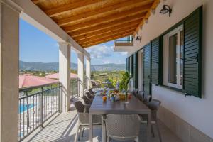 a table on the balcony of a house at Villa In Excelsis in Imotski