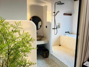 a bathroom with a sink and a tub and a mirror at Lotus Home Cafe in Phú Quốc
