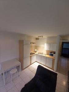 a kitchen with a couch and a table in a room at Ap5 Nature Ardennes Economy class apartment in La Calamine