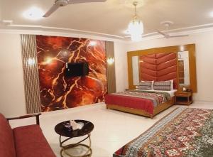 a living room with a bed and a couch at Travel lodge clifton in Karachi