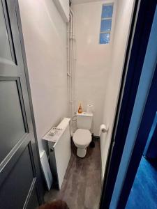 a small bathroom with a toilet and a sink at Le Lovely avec parking in Amiens