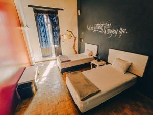 a room with two beds and a window at Hostal Regina Down Town Mexico City in Mexico City