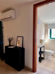 a bathroom with a toilet and a sink at The bell tower house in Castrofilippo