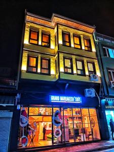 a building with a sign on the front of a store at Grand Marrakech Hotel in Yıldırım