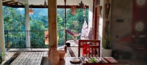 a room with a balcony with a view of trees at Tantra Ella Lodge in Ella