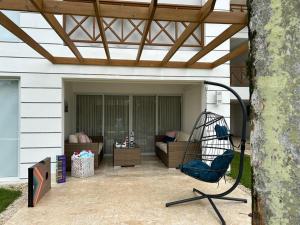 a patio with a swing and a couch at Casa Coral in San Felipe de Puerto Plata