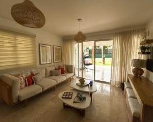 a living room with a couch and a table at Casa Coral in San Felipe de Puerto Plata