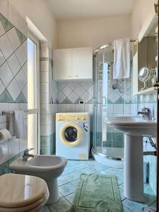 La salle de bains est pourvue d'un lave-linge et d'un lave-linge. dans l'établissement Casa vacanze L'Arco, à Striano