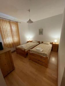 a bedroom with two beds and two night stands at Bungalow in ruhiger Lage in Dietachdorf