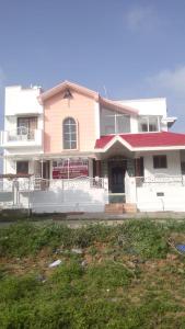 a large white house with a red roof at jayaram Home in Chittoor