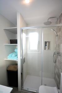 a shower with a glass door in a bathroom at Chiclana.Balconera.1ªlínea playa in Chiclana de la Frontera