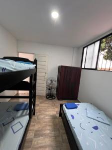 a room with two bunk beds and a window at Epifania Hostel in Cali