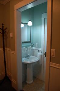 a bathroom with a white sink and a mirror at The Yellow Sidecar B&B in Cap Le Moine