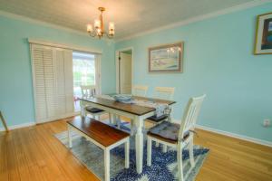 a dining room with a wooden table and chairs at Seashell Hideout with Pool in Ponte Vedra Beach