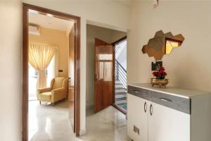 a hallway with a living room with a chair at 2 Bedroom Apartment near Vijayanagar, Bangalore in Bengaluru