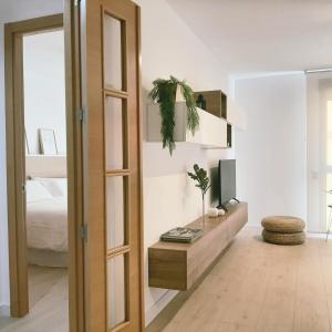 a living room with a tv and a mirror at Las Dos Torres in Teruel