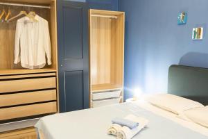a bedroom with a white bed and a closet at Le Terrazze sul Vesuvio in Naples