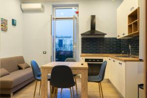 a kitchen with a table and chairs and a couch at Le Terrazze sul Vesuvio in Naples