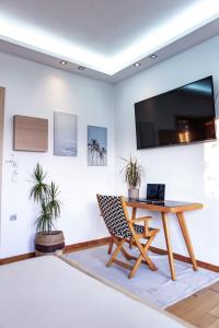 Televízia a/alebo spoločenská miestnosť v ubytovaní Panorama Loft