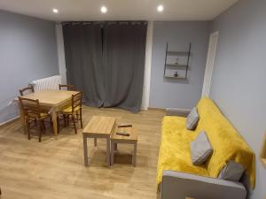 a living room with a couch and a table at Le Spacieux, Tendance et sa Vue Panoramique in Beauvais