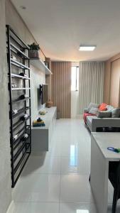 a living room with a couch and a table at Studio a 300m da praia in Maceió