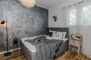 a bedroom with a bed with a blanket on it at Francesca Apartment in Bibinje