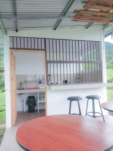 a room with two stools and a table and a mirror at Flora Glamping de Abuela in Fortuna