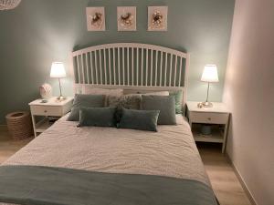 a bedroom with a large bed with two night stands at B&B Nathalie in Quartino