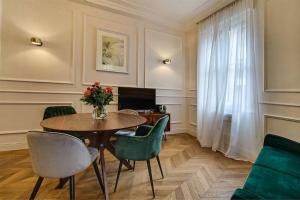 sala de estar con mesa y sillas verdes en Art Apartment Luxury Ponte Vecchio Suite, en Florencia