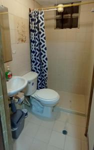 a bathroom with a toilet and a sink at CASA LATINO in Bogotá