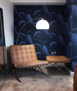 a bench in a room with a blue wallpaper at Stunning Flat in Hull's Vibrant Fruit Market & Marina in Hull