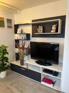 a flat screen tv on a white entertainment center at Cozy apartment in Ljubljana - Free parking in Ljubljana