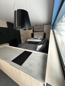 a living room with a couch and a bed at Rezidencia Hrabovo SKI IN-OUT in Ružomberok +83 photos