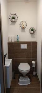 a small bathroom with a toilet and a sink at Charmante maison de plain-pied in Rochefort +16 photos