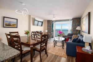 a living room with a table and a blue couch at Atlantica Resort in Myrtle Beach