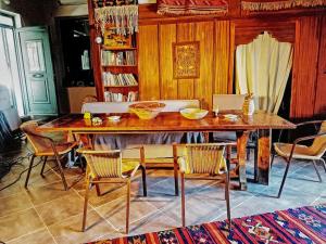 a dining room with a wooden table and chairs at Dinos' House in Skiros