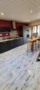 a kitchen with a wooden floor and a table and chairs at Gite du bourbouillon in Largillay-Marsonnay