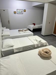Postel nebo postele na pokoji v ubytování Piúma Palace Hotel