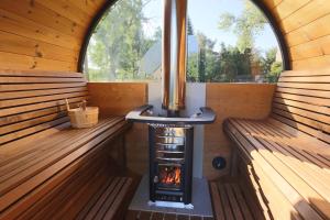 a wood fired stove in a sauna with two benches at Urige Wohnung mit zwei Betten und genialer Küche in Mügeln
