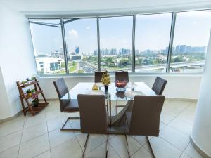 a dining room with a glass table and chairs at Avantha By Afi luxury 2BHK apartment in Dubai