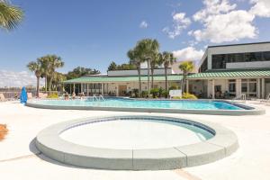 a large swimming pool in front of a building at Sandestin Bayfront Studio with balcony and breathtaking views in Destin