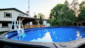 a swimming pool with two chairs in a house at Vacation home/Cottage on Private 20 Acres Land - Resort-a/Spa Cottage in Cookstown