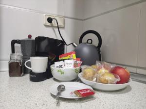 a kitchen counter with two bowls of food and a coffee maker at Granada Historic Center Apartment in Granada +10 photos