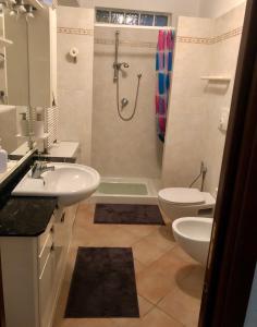 a bathroom with a sink and a toilet and a shower at Casa Sara in Monopoli