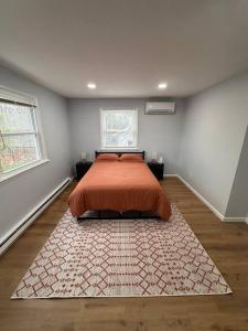 a bedroom with a bed and a rug on the floor at Home sweet home in woods in Tobyhanna