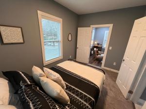 a bedroom with two beds and a window at Mid Century 1/4 mile to Downtown Main Street - breweries, coffee, dining, shops in Monroe