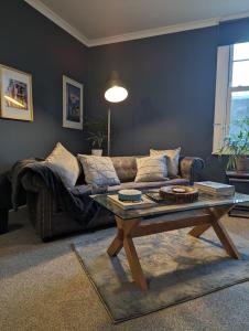 a living room with a couch and a coffee table at Avon’s Rest in Stratford-upon-Avon