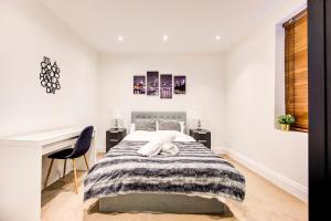 a white bedroom with a bed and a desk at Affordable Apartment In London Bridge - 10 Per Cent Off Weekly Bookings! in London