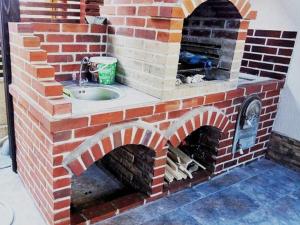 a brick oven with a sink in it at Vila Adelin in Tăşnad