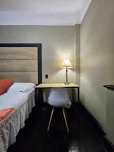 a bedroom with a desk with a bed and a lamp at Hotel-Studio @ The Mansfield Midtown in New York